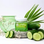 Aloe vera gel jar surrounded by cucumber slices, green accents, and white floral elements for a fresh aesthetic.
